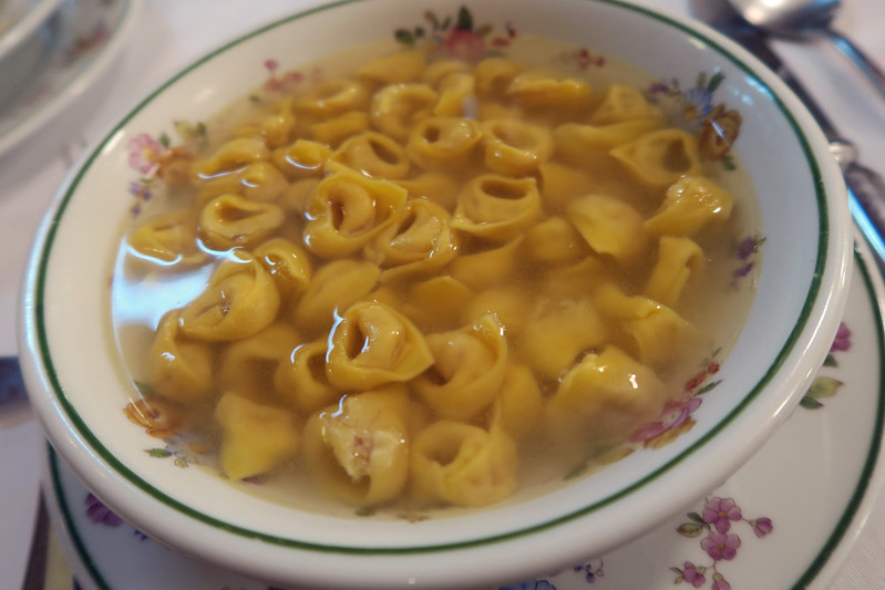 Bowl of authentic tortellini in brodo, the classic Bologna meat broth soup served in the city