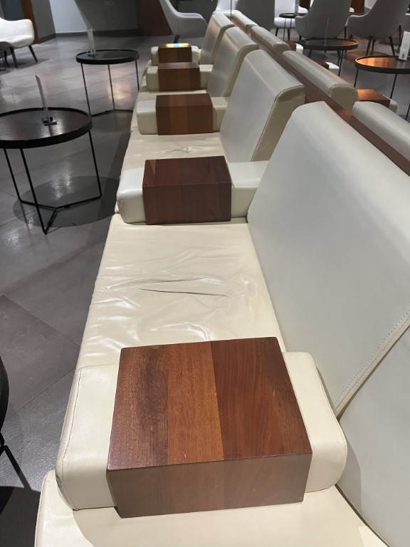 La Valette Lounge Malta: cream leather bench seating with walnut wooden armrest blocks