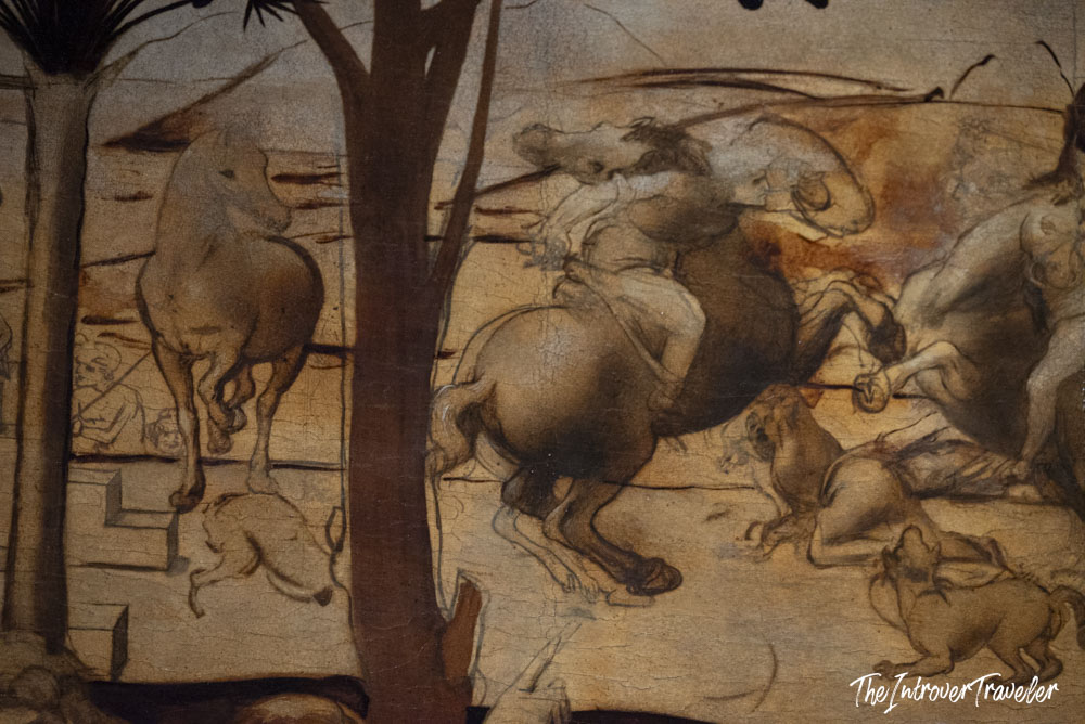 Detail of Leonardo da Vinci's Adoration of the Magi, showing dynamic horses and figures at the Uffizi Gallery