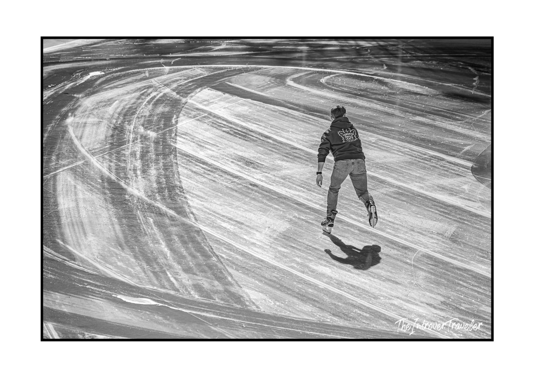 Lone skater gliding across the Wollman Rink ice in Central Park, New York