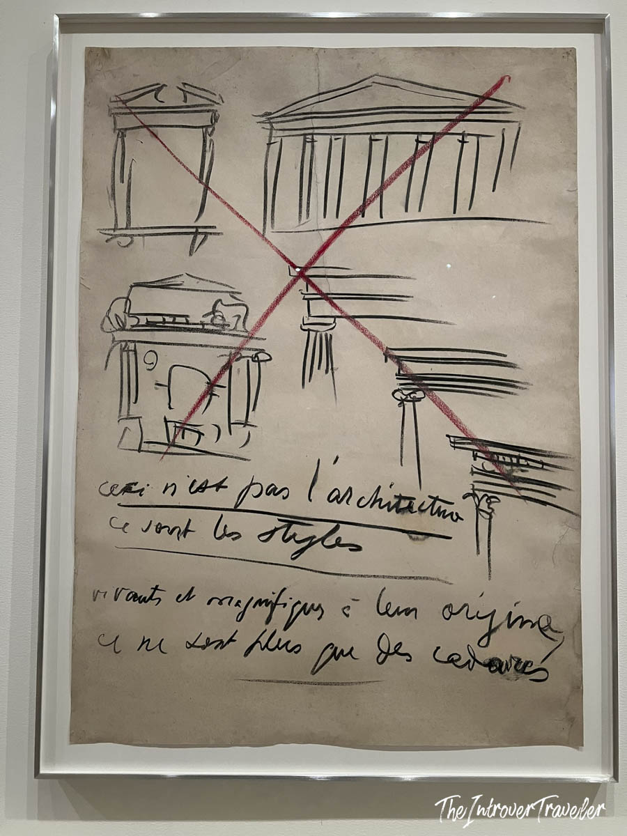 Le Corbusier architectural sketch with red X marks and French handwritten text, displayed at MoMA New York