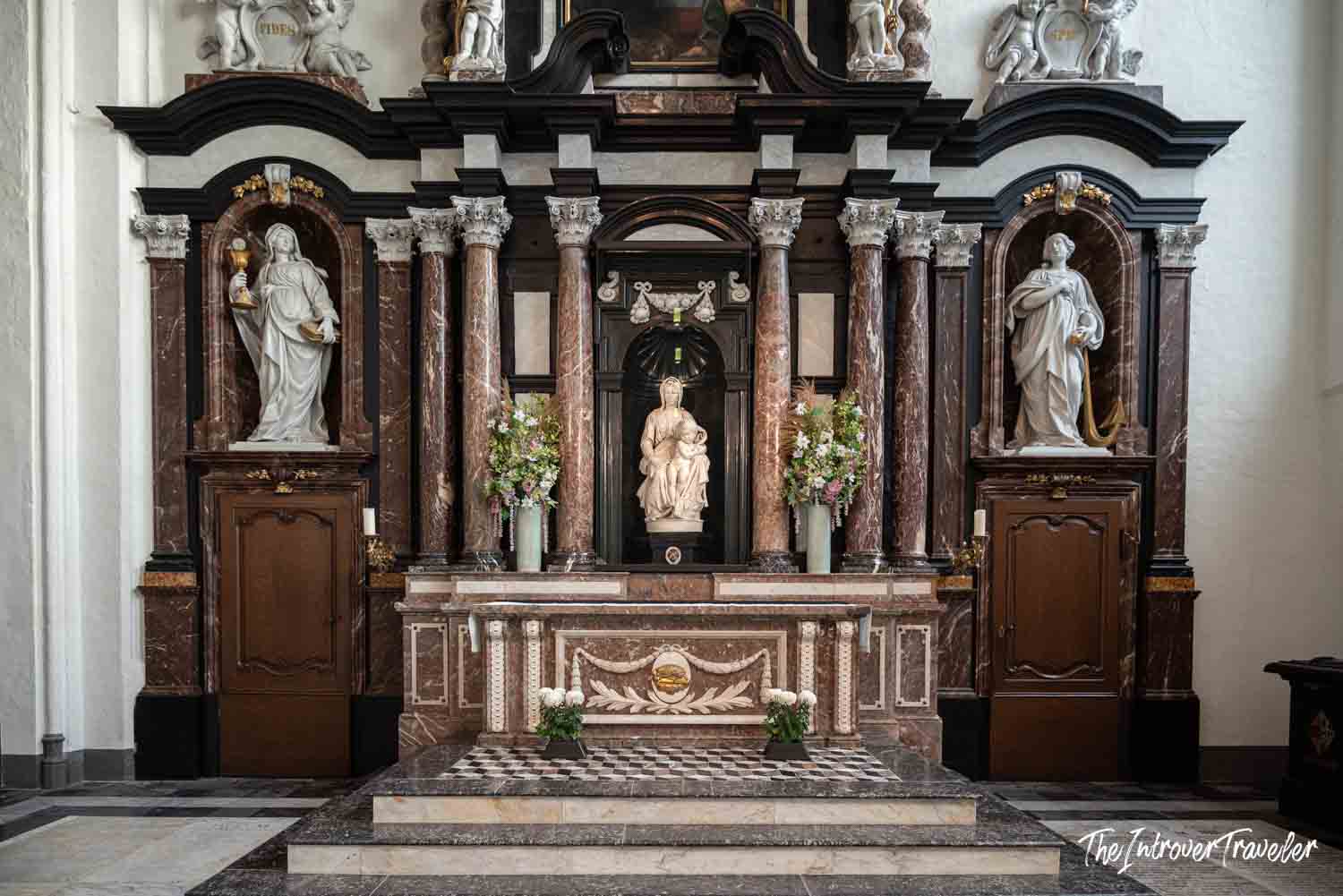 Michelangelo's Madonna of Bruges displayed in the baroque altar of the Church of Our Lady
