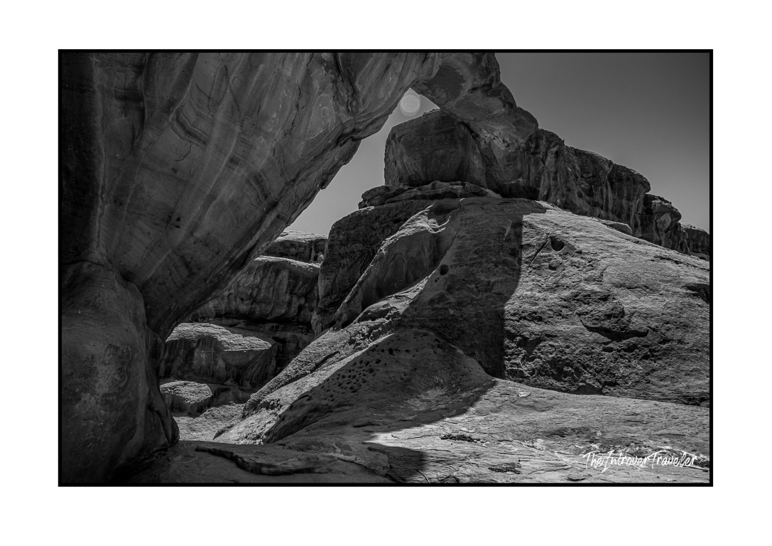 Black and white view through a natural sandstone arch in Wadi Rum desert, Jordan