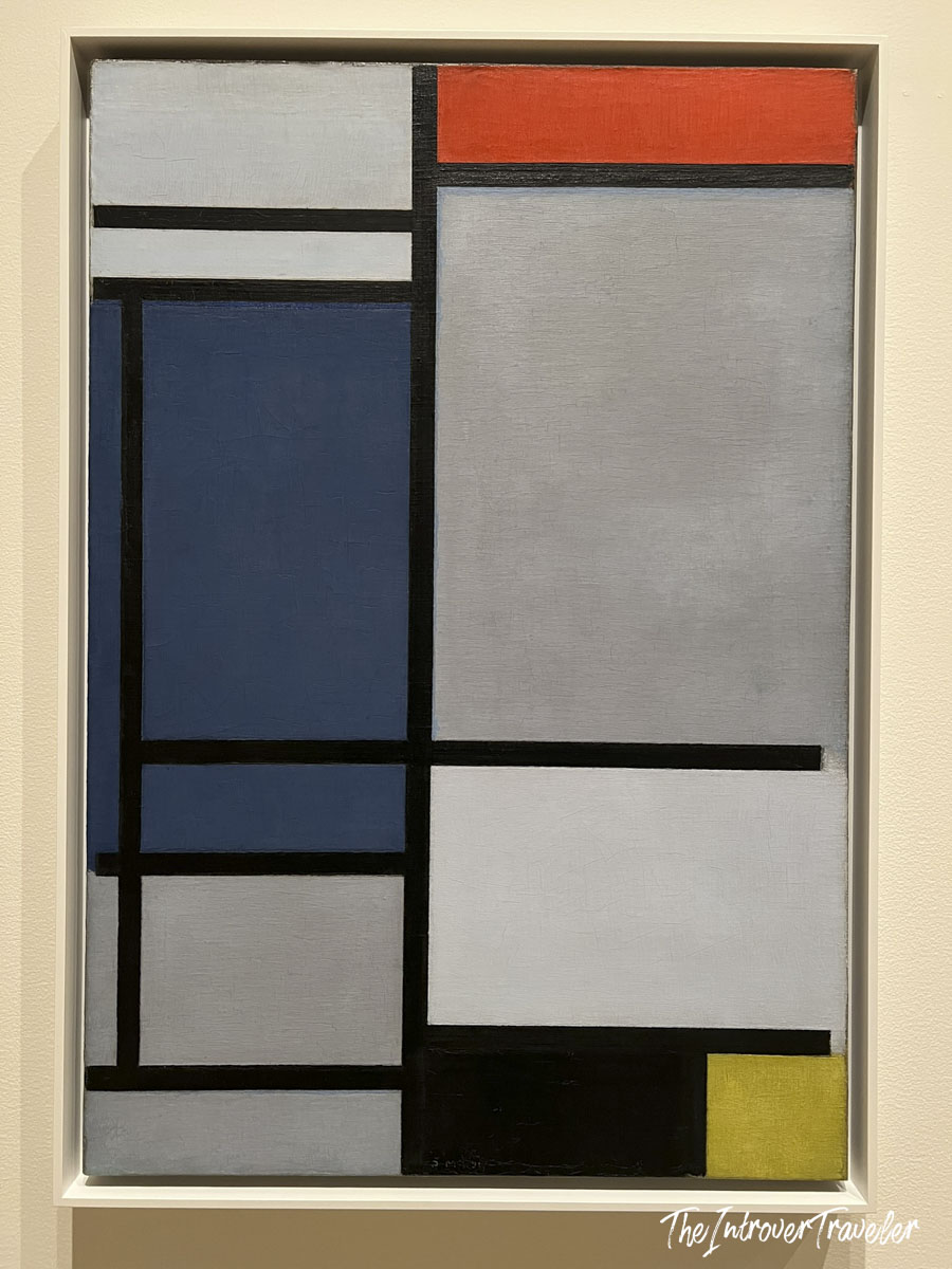 Mondrian neoplastic composition with red, blue, yellow, black grid lines displayed at MoMA New York