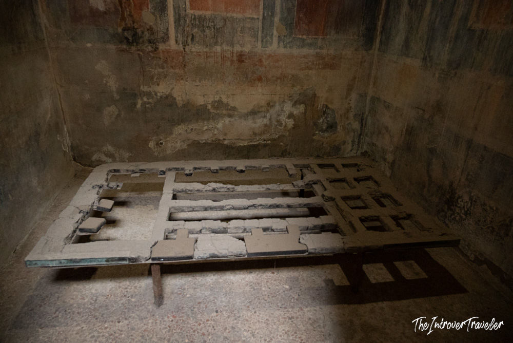 Ancient Roman bed frame preserved in a cubiculum at the Herculaneum excavations, Italy