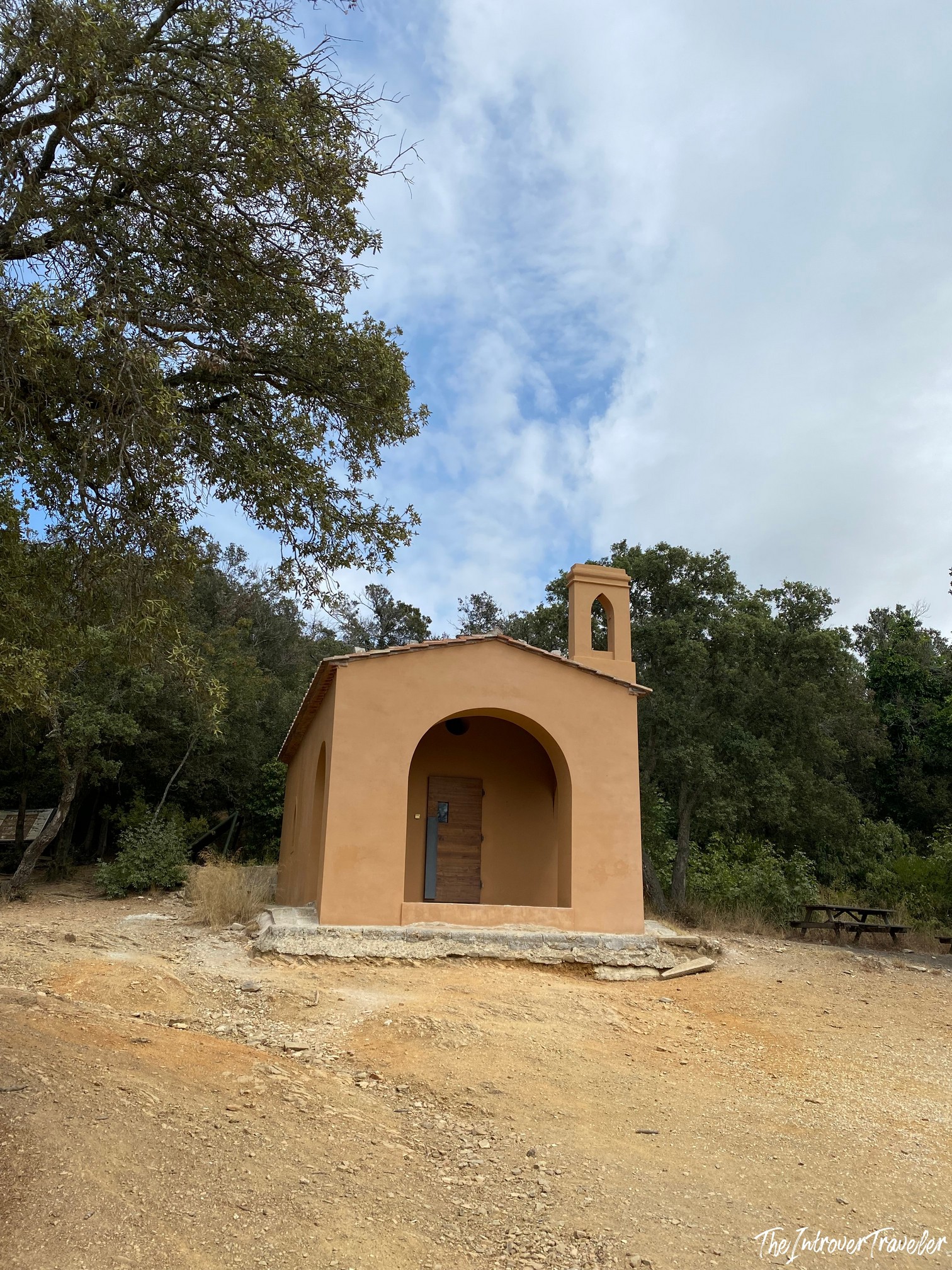 Small ochre chapel with bell tower along the Cala Moresca to Buca delle Fate trekking route, Sardinia