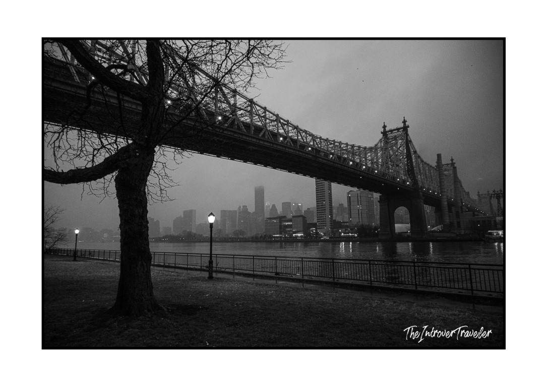 Queensboro Bridge and misty Manhattan skyline viewed from Roosevelt Island on a rainy December evening