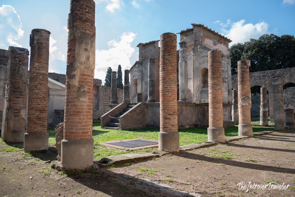 Rows of ancient brick columns and temple ruins at the archaeological site of Pompeii, Italy