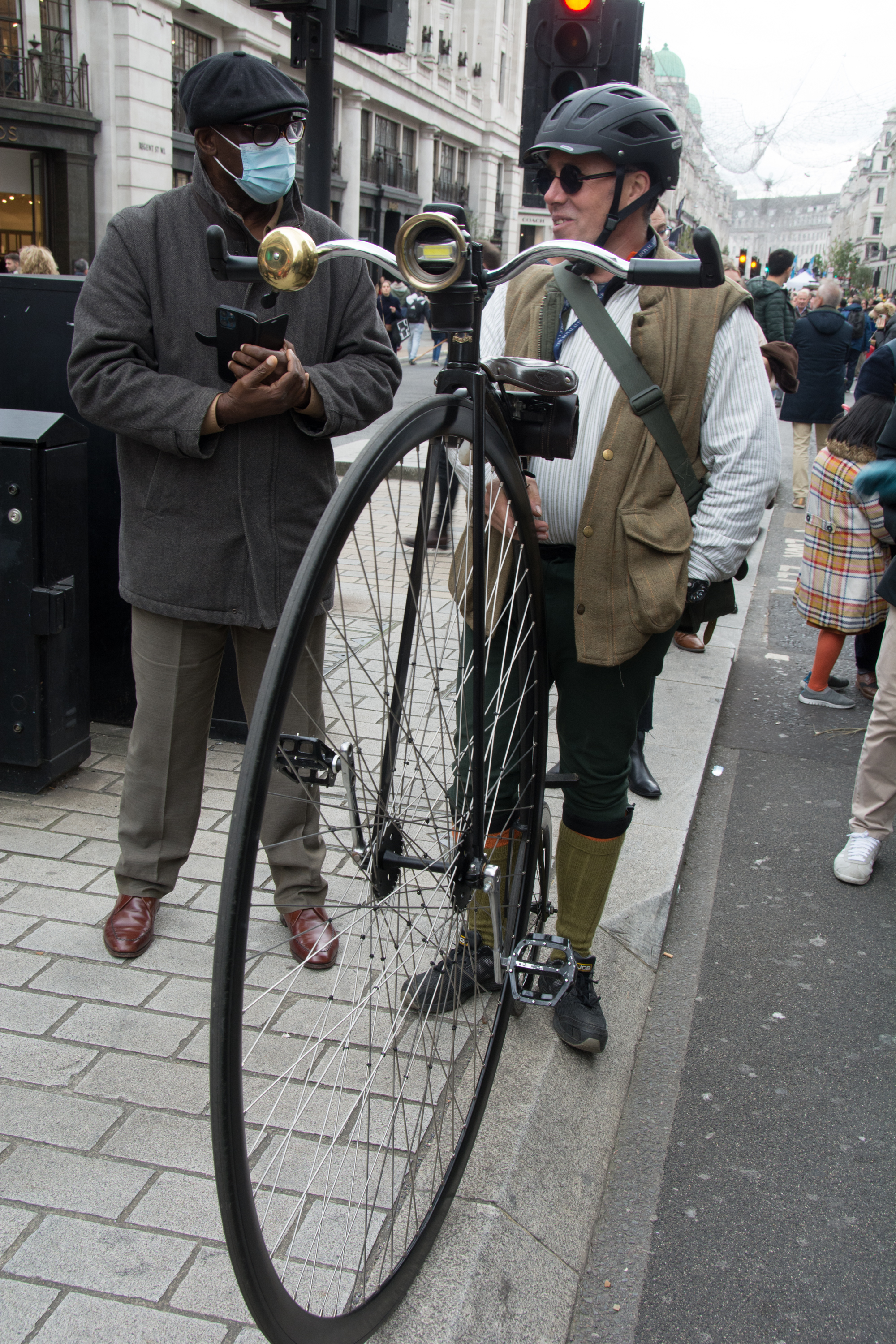 Penny-farthing bicycle rider in tweed on Regent Street during a London weekend visit