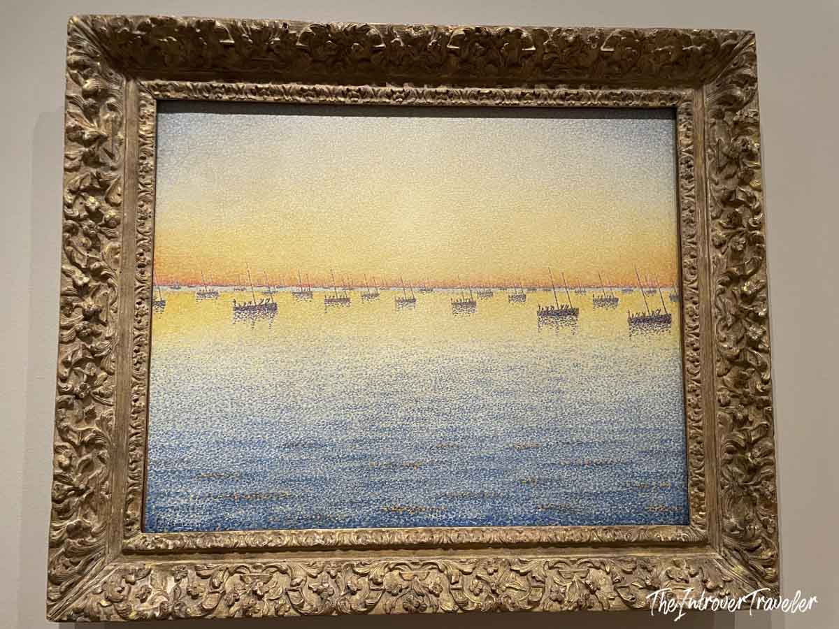 Pointillist seascape with sailboats at sunset, a Neo-Impressionist work on display at MoMA New York