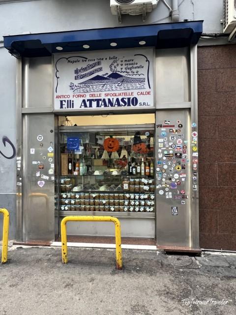 Flli Attanasio sfogliatelle bakery storefront in Naples, a historic pastry shop covered in stickers