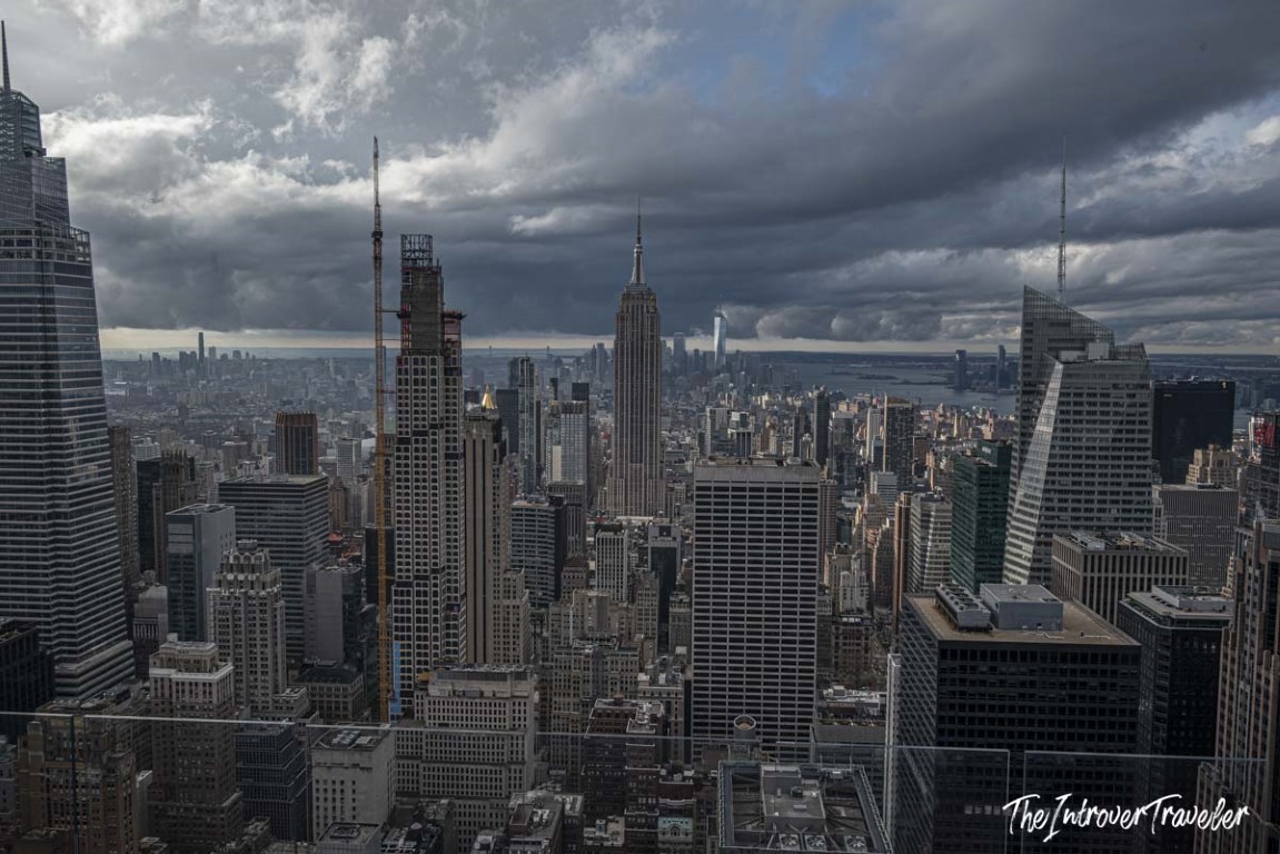 Manhattan skyline viewed from Top of the Rock, with the Empire State Building centered under stormy skies