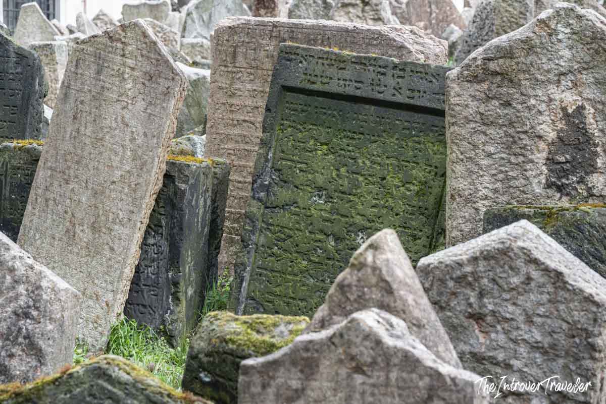 Densely packed Hebrew tombstones leaning at angles in the Old Jewish Cemetery, Prague