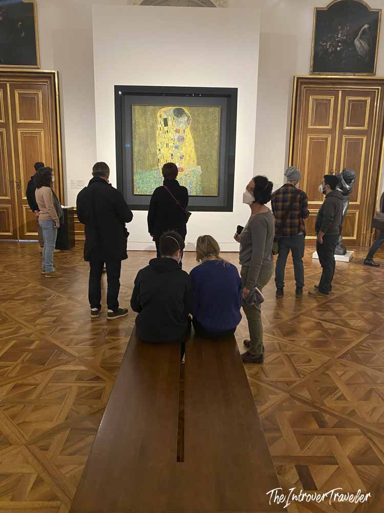 Visitors viewing The Kiss by Gustav Klimt at the Belvedere Museum in Vienna