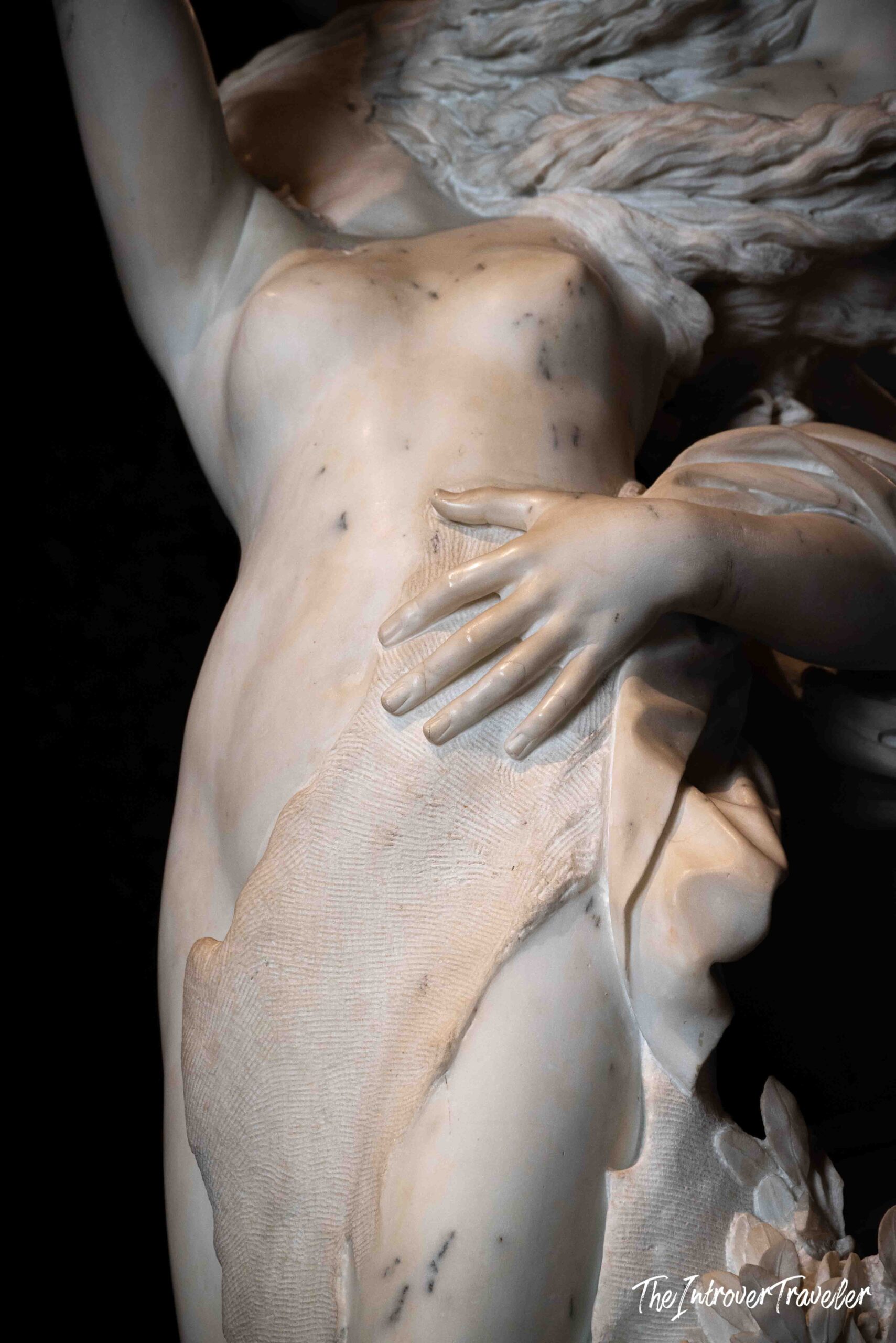 Close-up of Bernini's Apollo and Daphne, showing finely carved marble hands and draped fabric at Borghese Gallery