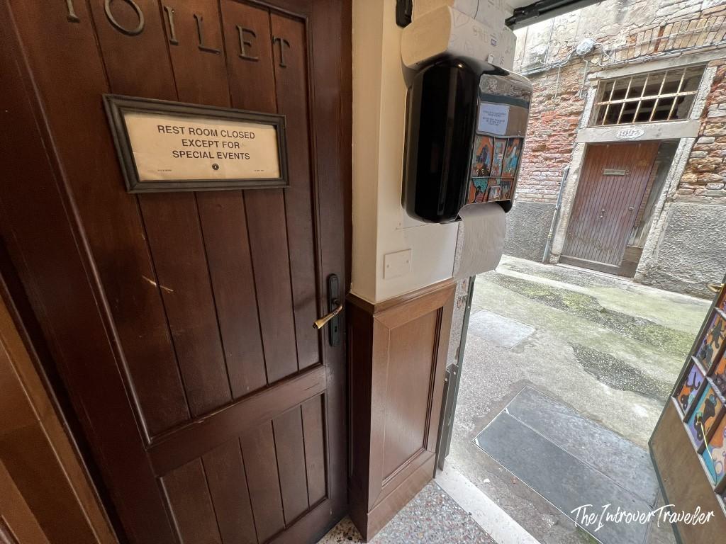 Toilet door at Le Antiche Carampane Venice, closed except for special events, opening onto the street