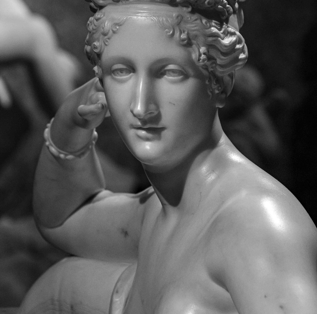 Close-up of Canova's Pauline Borghese as Venus Victrix, highlighting her idealized face and pearl bracelet.