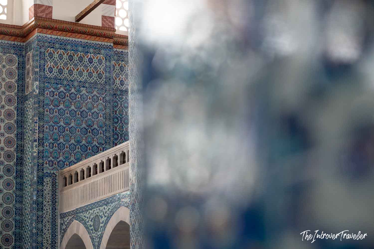 Intricate blue Iznik tile panels on a mosque interior column in Istanbul