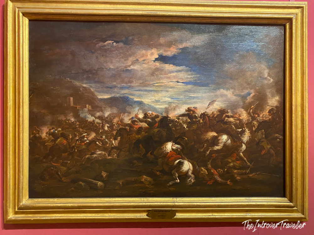 Battaglia painting by Salvator Rosa in a gilded frame, displayed inside a Lucca palace