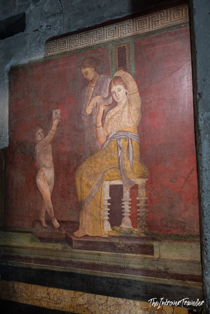 Ancient Roman fresco in the Villa of the Mysteries, Pompeii, showing a woman being adorned by attendants