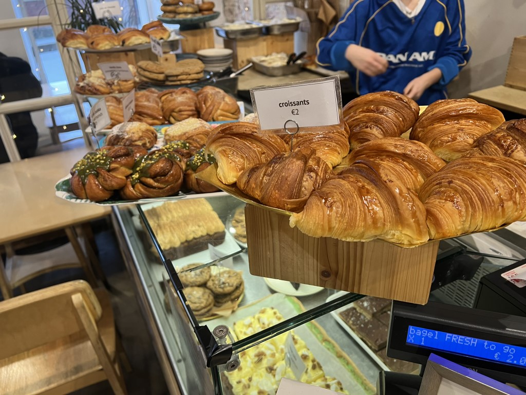 Golden croissants priced at 2 euros displayed at Melaleuca Bistrot bakery counter in Florence