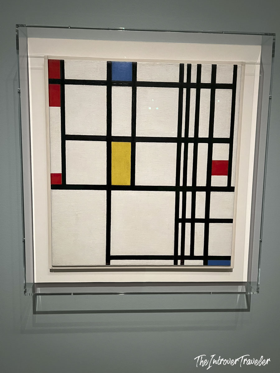 Mondrian abstract grid painting with red, blue, and yellow blocks displayed at MoMA New York