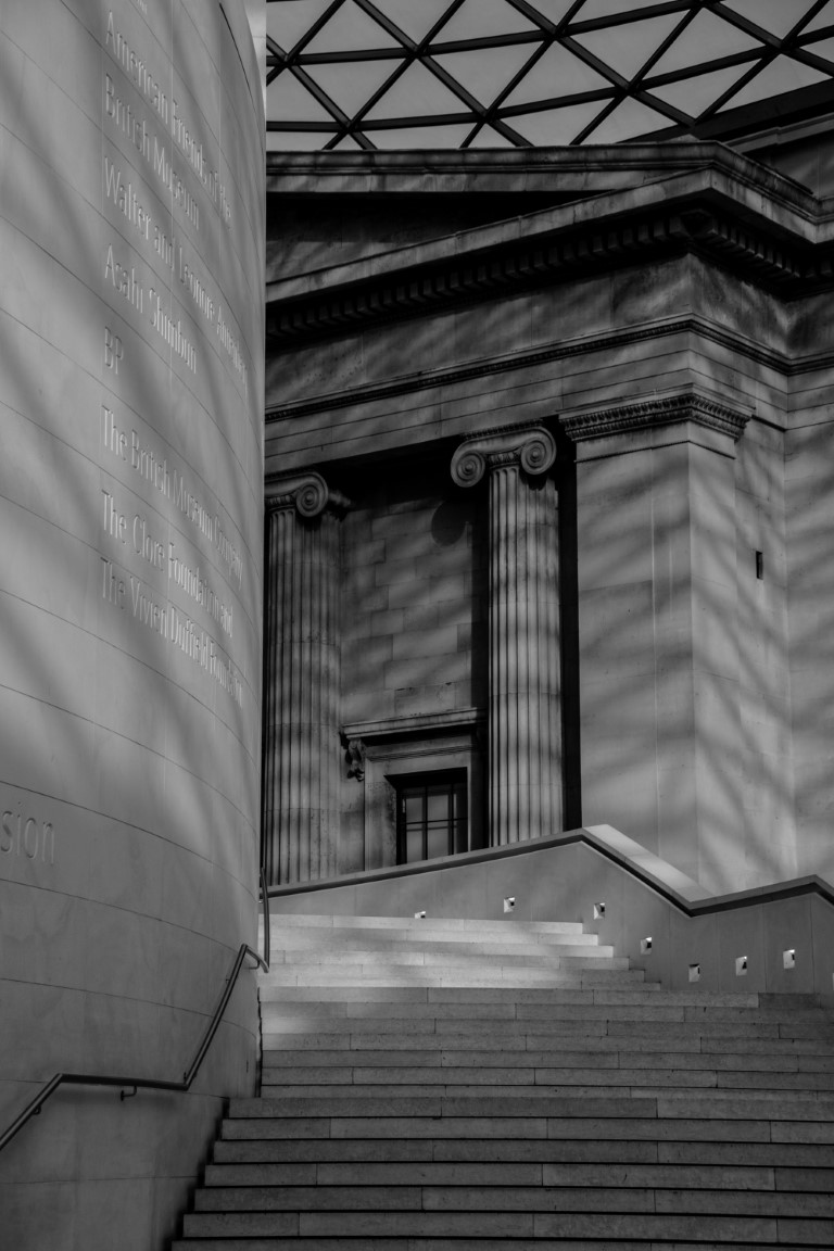 British Museum Great Court interior, ionic columns and glass roof casting dramatic shadows
