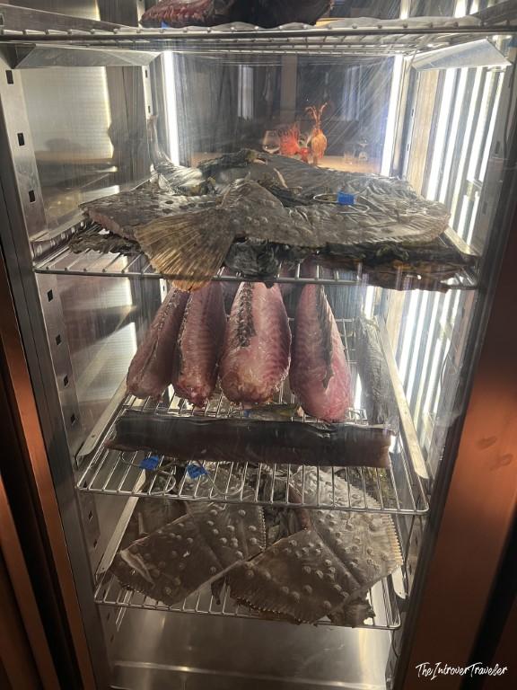 Whole fish aging in a dry-aging fridge at Trattoria Da Lucio, a fine dining seafood restaurant in Rimini