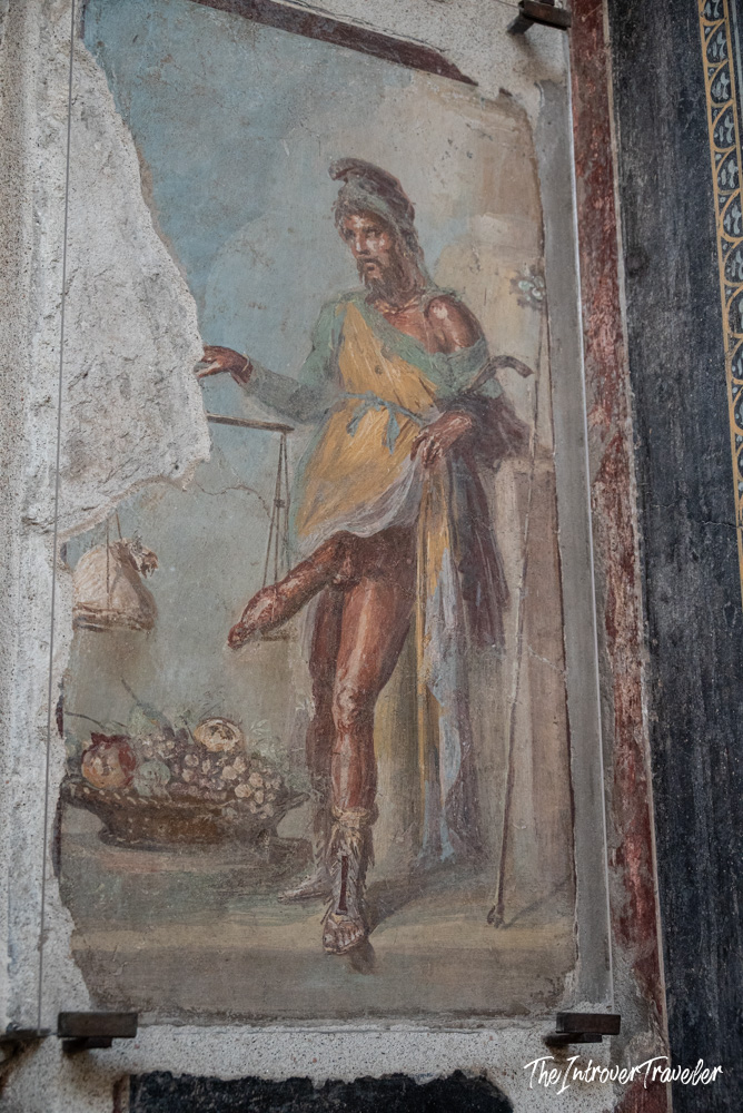 Ancient Roman fresco of Priapus with scales and fruit, House of the Vettii, Pompeii
