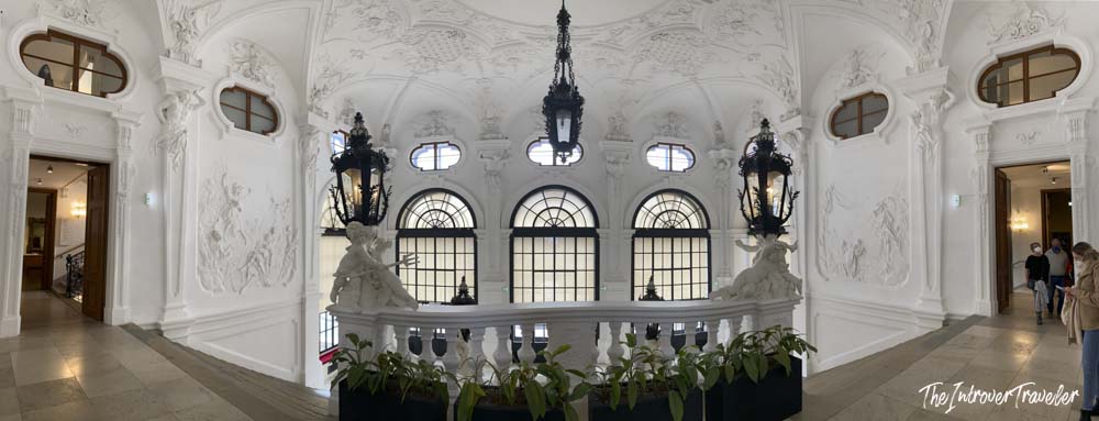 Ornate white Baroque staircase hall inside the Belvedere Palace museum in Vienna