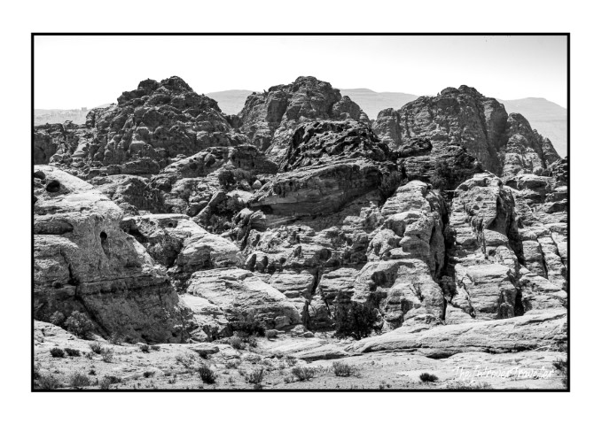 Black and white view of Petra's rugged sandstone rock formations, Jordan's ancient Nabataean landscape