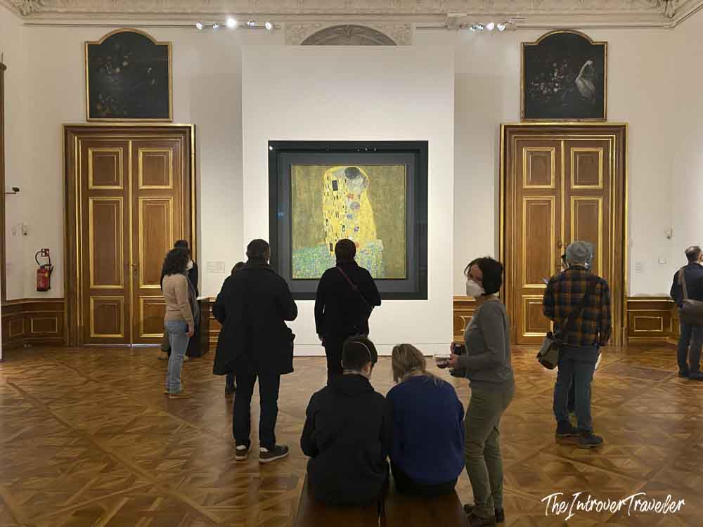 Visitors admiring The Kiss by Gustav Klimt at the Belvedere Museum in Vienna