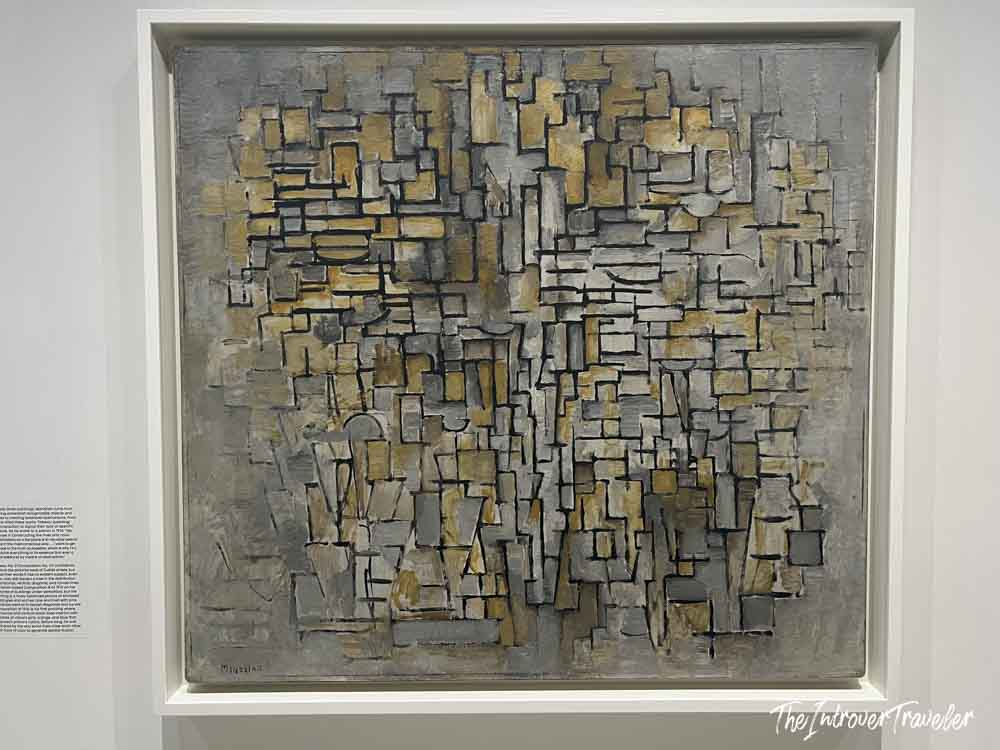 Mondrian abstract cubist painting in muted gold and grey tones, displayed at the Guggenheim New York