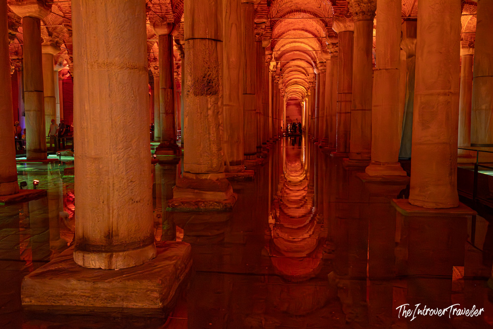 Basilica Cistern Istanbul, rows of ancient columns reflected in red-lit water below