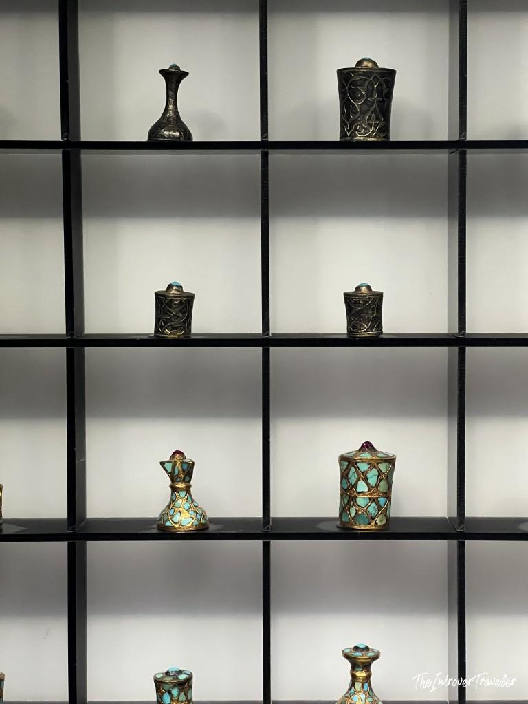 Ornate Ottoman perfume bottles with turquoise and metalwork filigree on display at Topkapi Palace, Istanbul