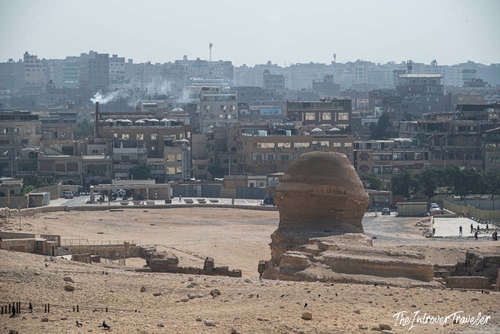 Great Sphinx of Giza seen from above, with the sprawling Cairo cityscape behind it