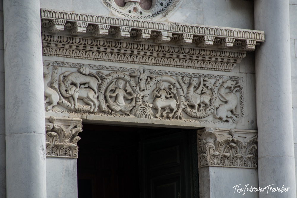 Intricate marble relief carvings above a portal of Lucca Cathedral, San Martino, Tuscany