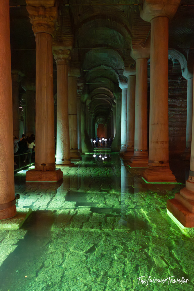Basilica Cistern Istanbul interior, rows of ancient columns reflected in green-lit water below