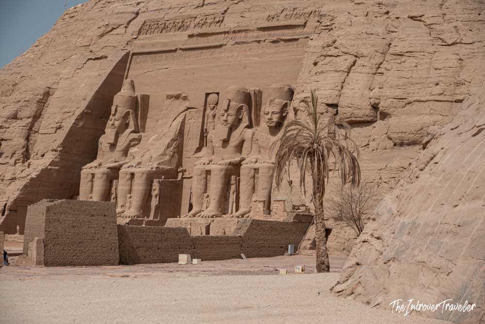 Four colossal Ramesses II statues carved into the sandstone facade of Abu Simbel temple, Egypt