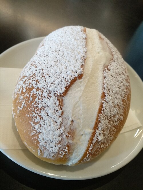 Maritozzo con la panna, a Roman sweet bun filled with whipped cream, dusted with powdered sugar