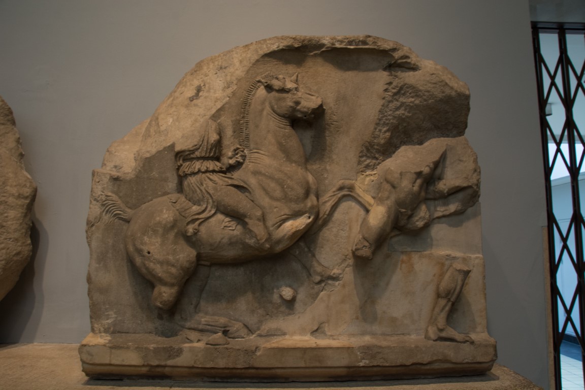 Ancient Greek stone relief showing a rider on horseback, on display at the British Museum London