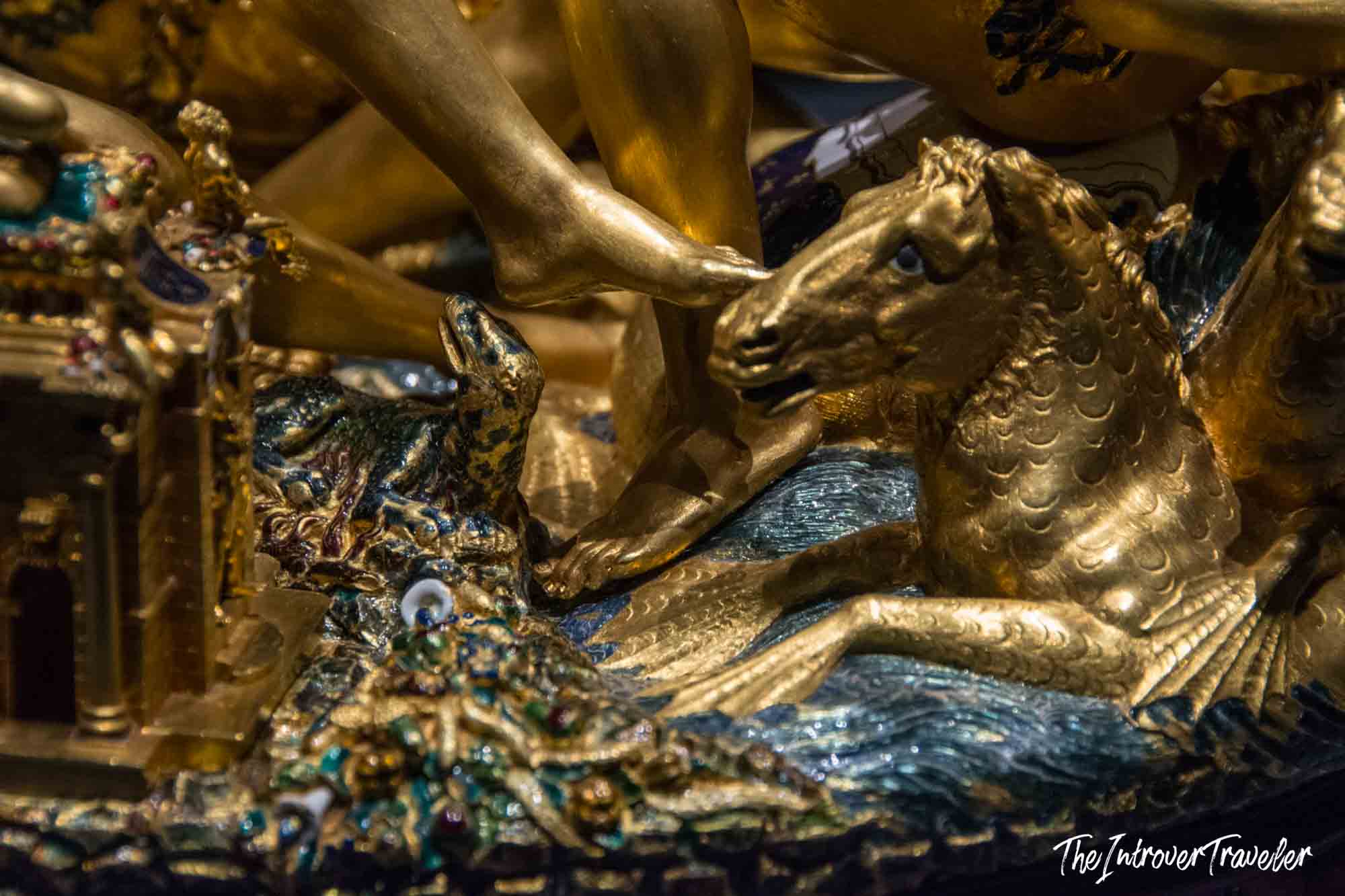 Close-up of gilded sea creatures on the Cellini Salt Cellar, showing intricate enamel and gold craftsmanship