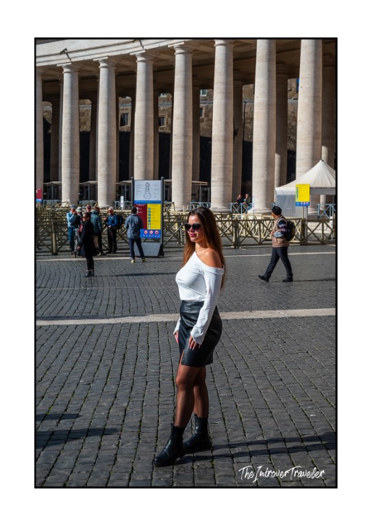 Traveler posing in St. Peter's Square, Vatican, with Bernini's iconic colonnade columns behind her