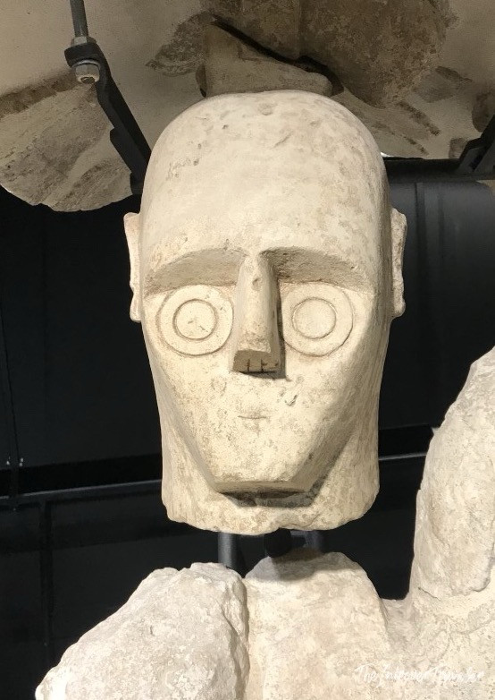 Ancient Giants of Mont'e Prama stone head, with iconic circular eyes, on display in Cagliari