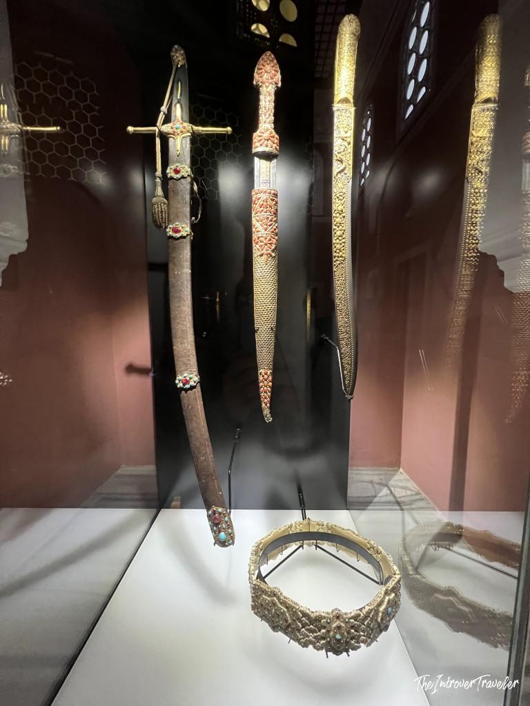 Jewel-encrusted Ottoman swords and ceremonial bracelet on display at Topkapi Palace, Istanbul