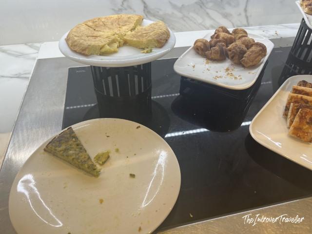 Tortilla española and pastries on the buffet at the Pau Casals Lounge, Barcelona El Prat Airport