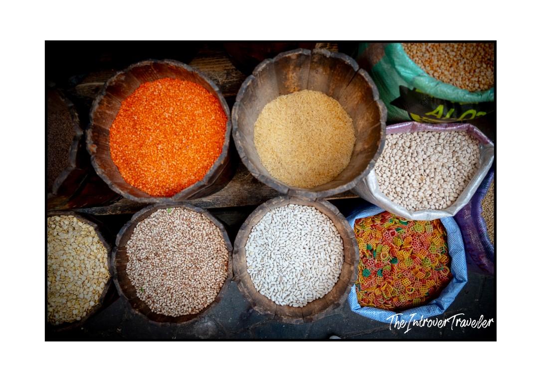 Wooden bowls and sacks of lentils, rice, beans, and pasta at an Egyptian market stall