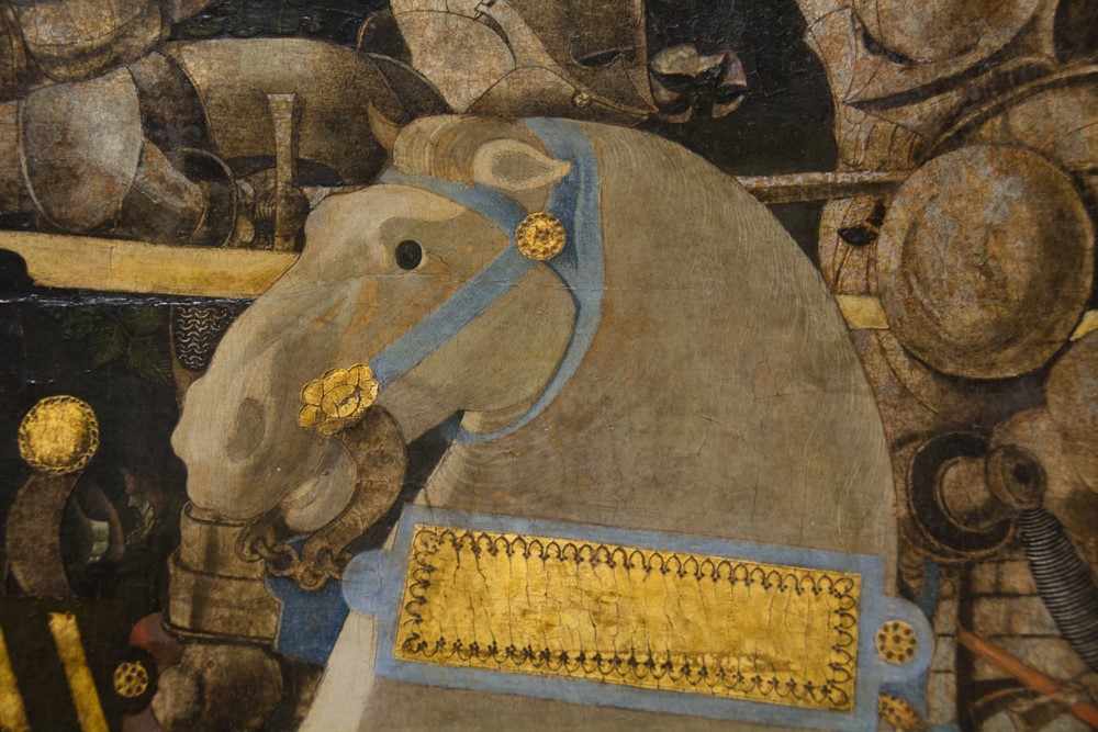 Close-up of a gilded caparisoned horse in a Renaissance battle painting at the National Gallery, London