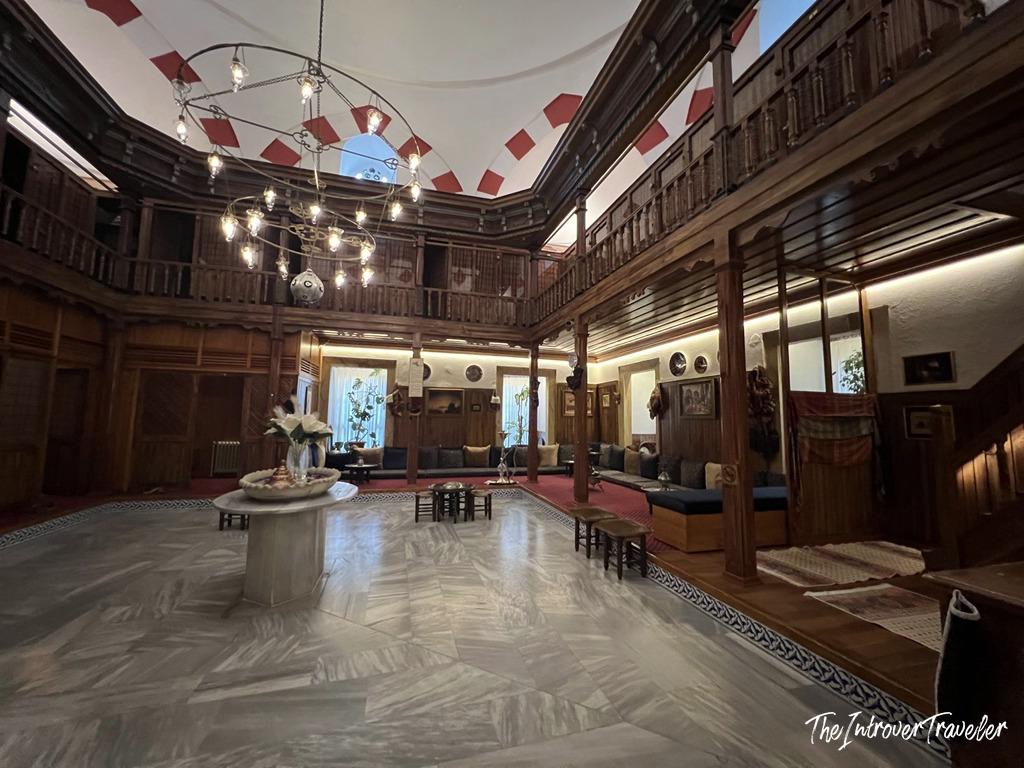 Grand reception hall of Süleymaniye Hamam in Istanbul, with carved wood balconies and domed ceiling