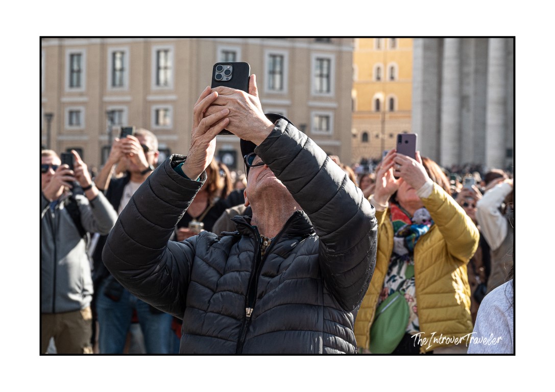 Crowd of tourists photographing the Pope's Angelus address in St. Peter's Square, Vatican